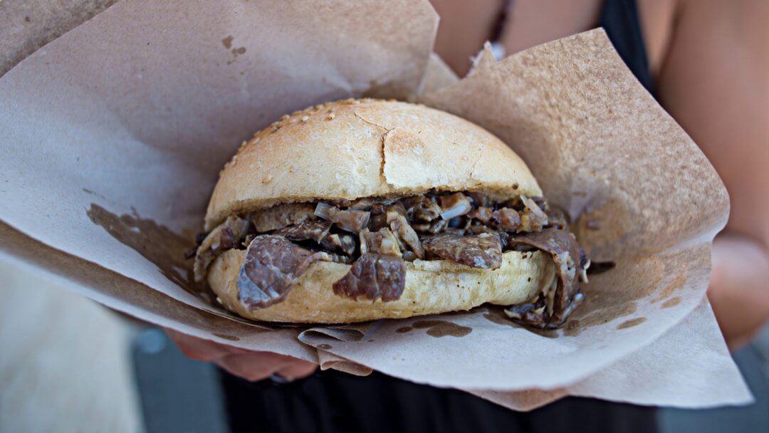 sandwich with spleen as it goes in the street food experience in Palermo
